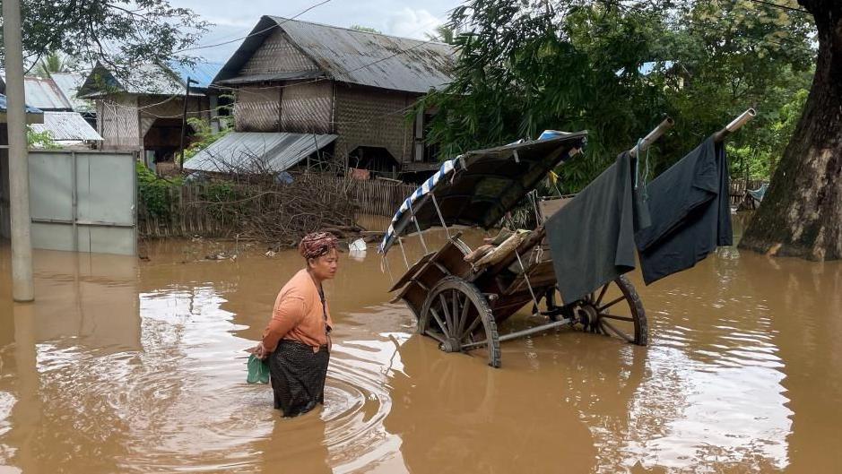 A woman stands in flood waters in Pyinmana, Naypyidaw, Myanmar, 13 September 2024.