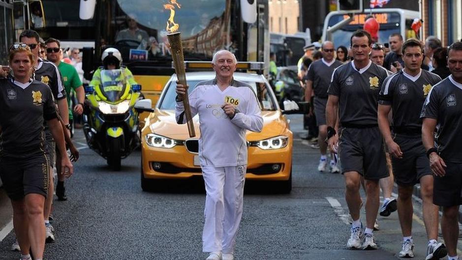 Stan Wild carrying Olympic torch