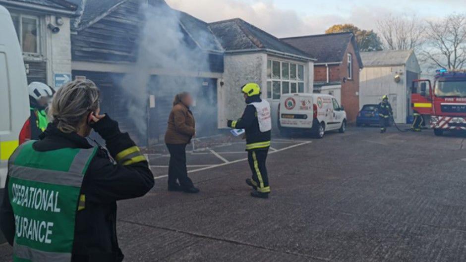 Several firefighters and other people involved in a fire safety training exercise.