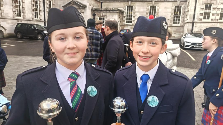 Molly Bell and Rosie McKinstry are both wearing navy uniforms and hats and both have dark hair tied back 