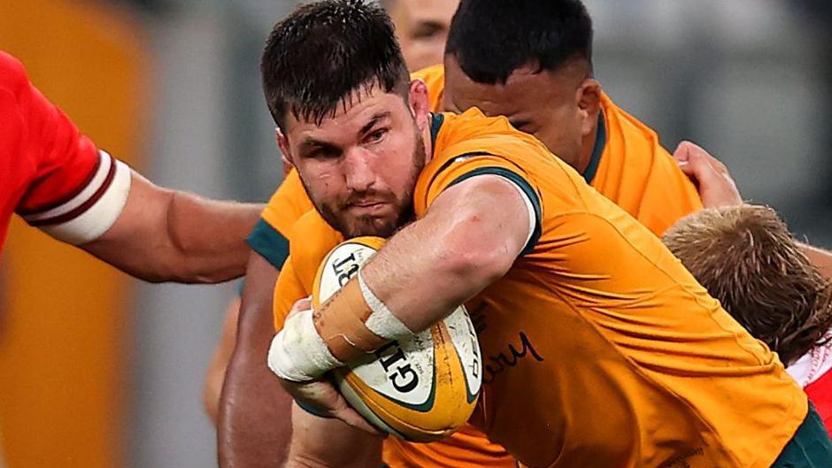Liam Wright of Australia is tackled during a Test against Wales