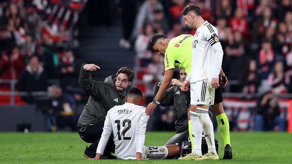 Trent Alexander-Arnold receives treatment on the pitch