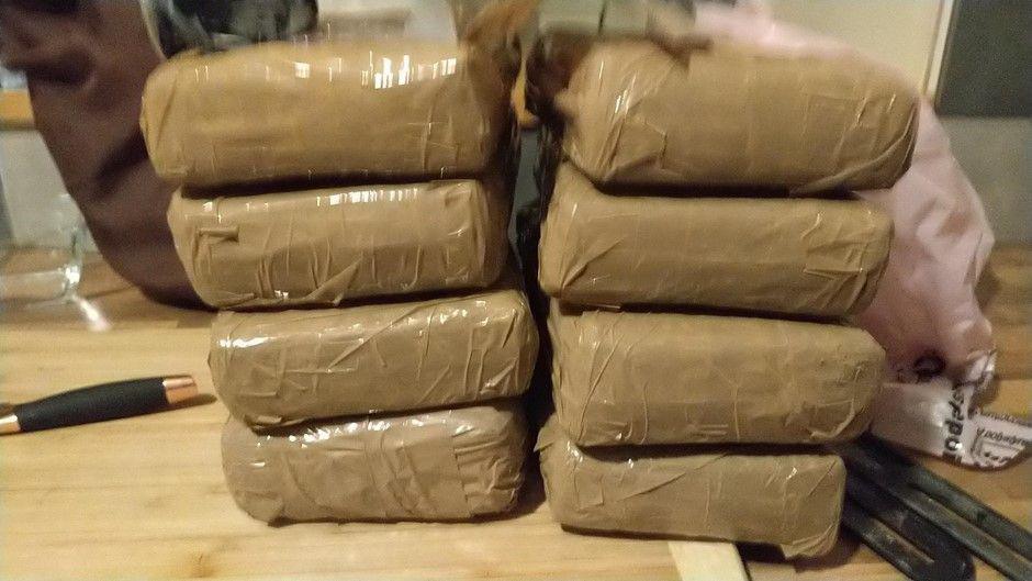 Eight stacks of cocaine wrapped in brown tape.