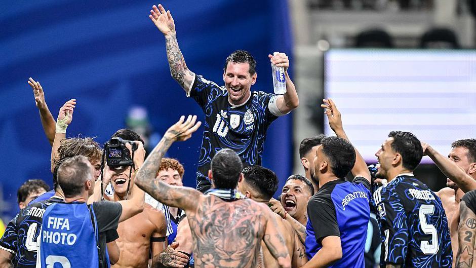 Lionel Messi is raised onto the shoulders of his Argentina team-mates celebrating their win over England