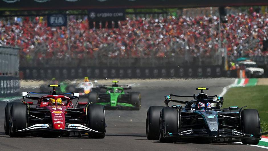 Ferrari's Lewis Hamilton moves alongside Mercedes' Kimi Antonelli as he attempts an overtake along the start-finish straight during the Emilia-Romagna Grand Prix