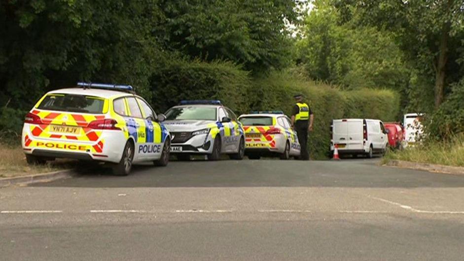 Police vehicles near scene