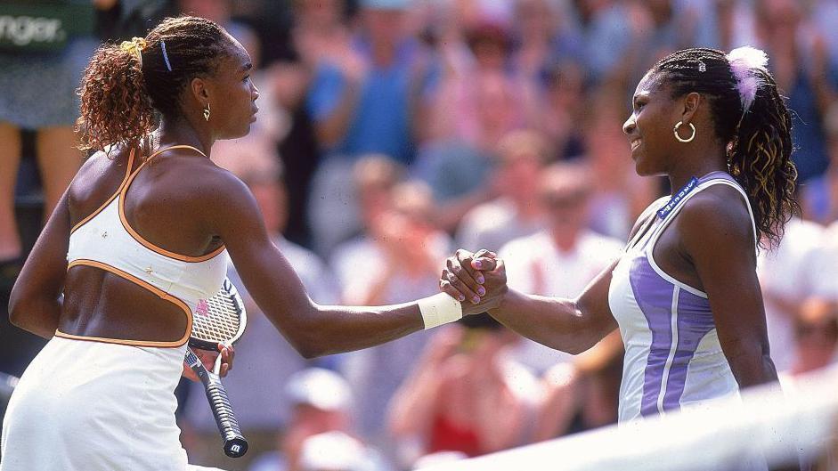 Venus and Serena Williams lock hands at the net after their 2000 Wimbledon semi-final