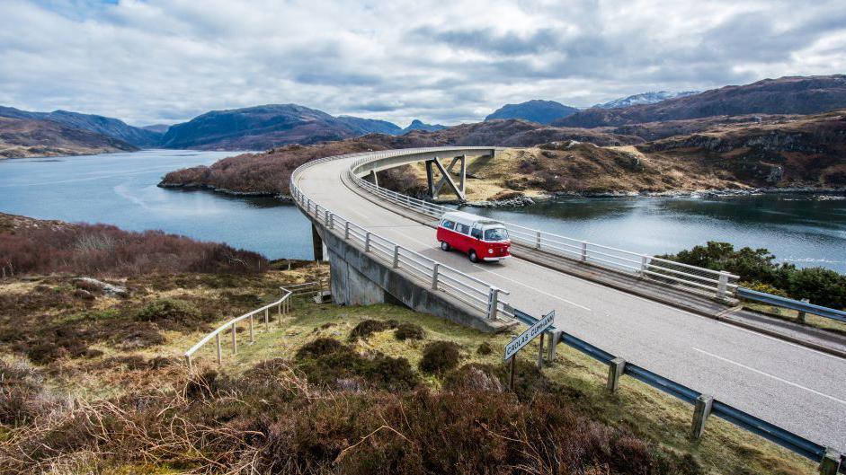 A campervan crossing Kylesku Bridge in the Highlands