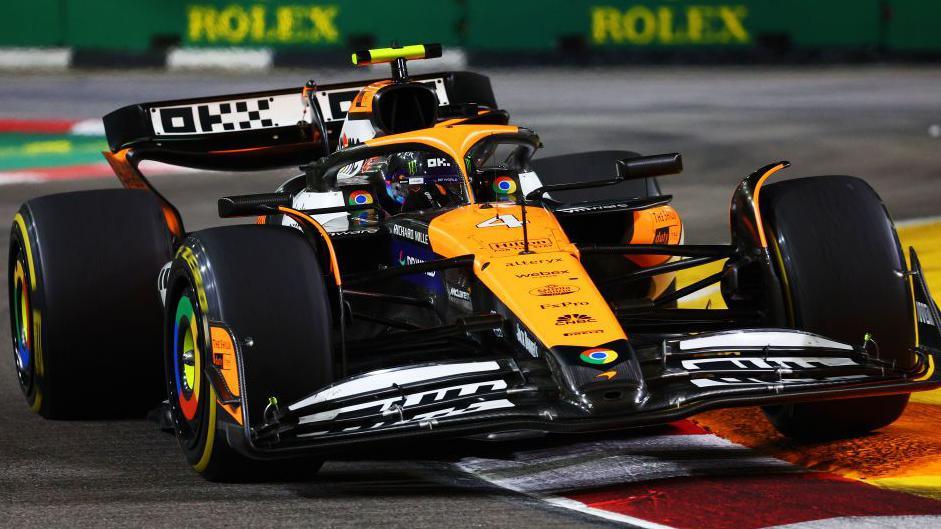 Lando Norris' McLaren rides a kerb during the Singapore Grand Prix 