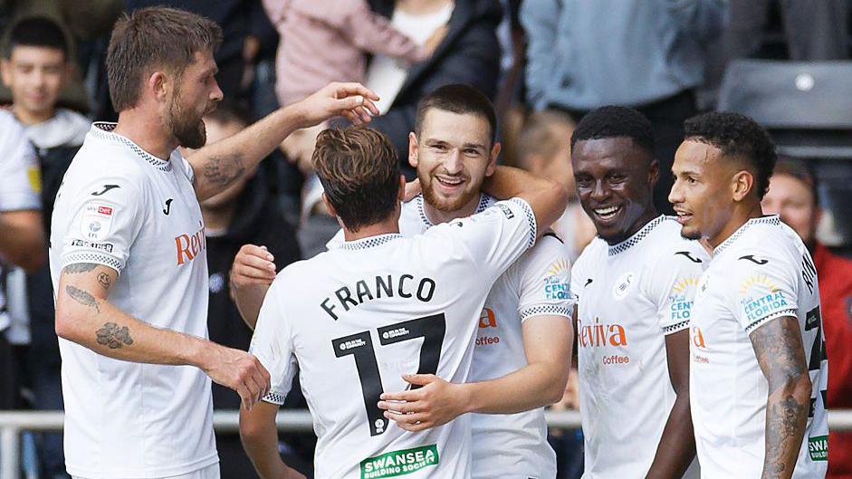 Swansea players celebrate a Zan Vipotnik goal 