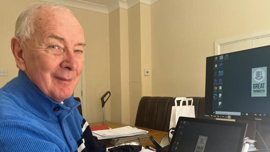 Councillor Trevor Wainwright, labour group leader, sitting at his desk with computer screens in front of him.