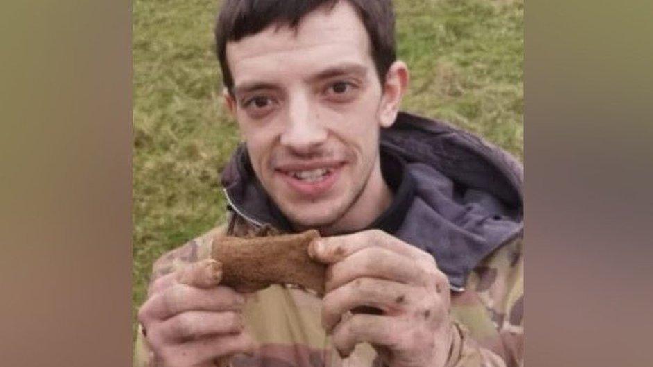 Josh holds up an axe head