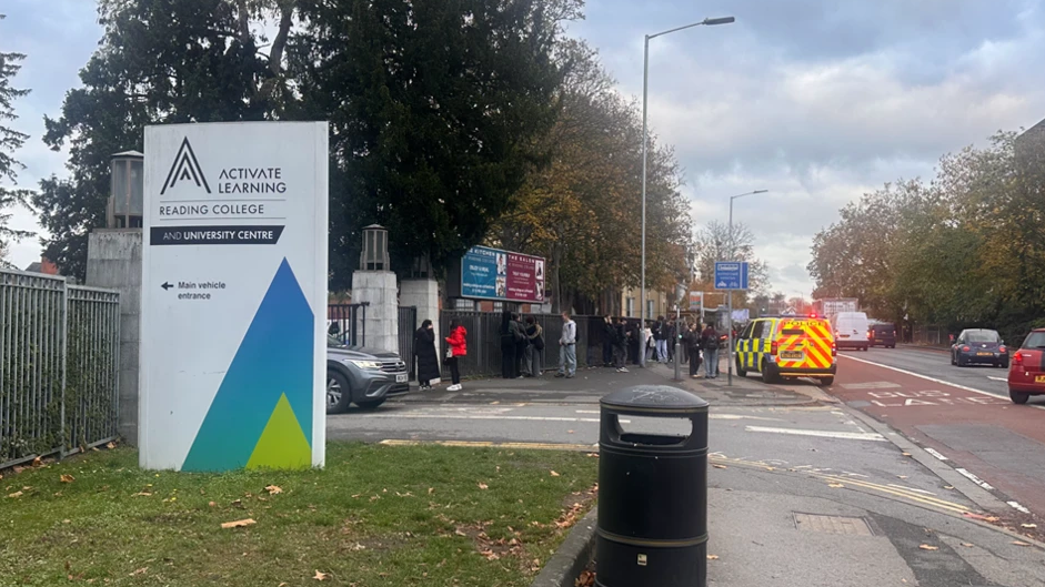 A general view picture of Reading College's sign on the left, next to its entrance, and a police van parked on the side of Kings Road.
