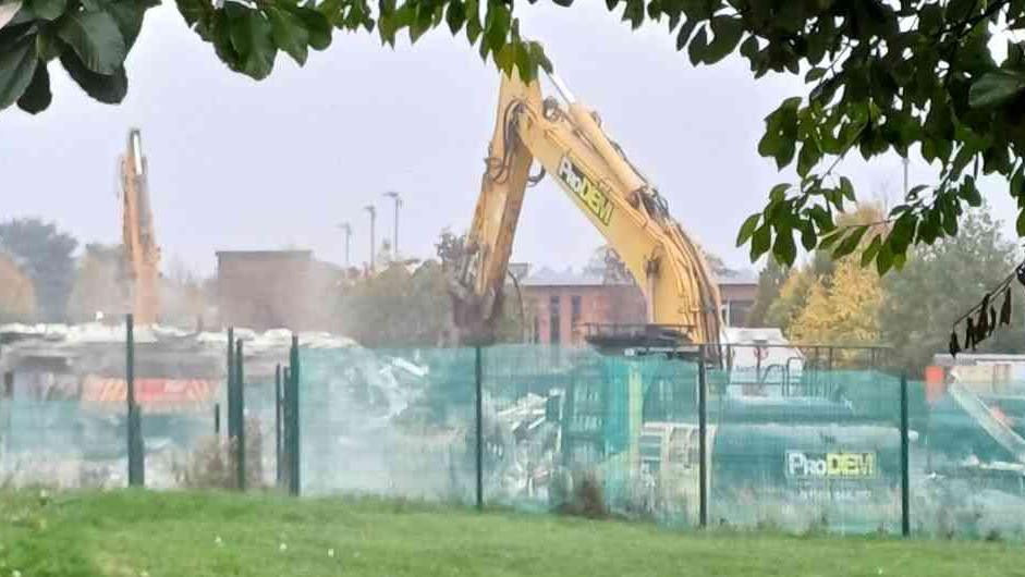 A building site where two construction vehicles are demolishing a building