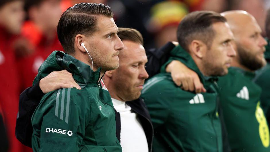 Piet Cremers, Craig Bellamy, Andrew Crofts and James Rowberry line up for the Welsh anthem 