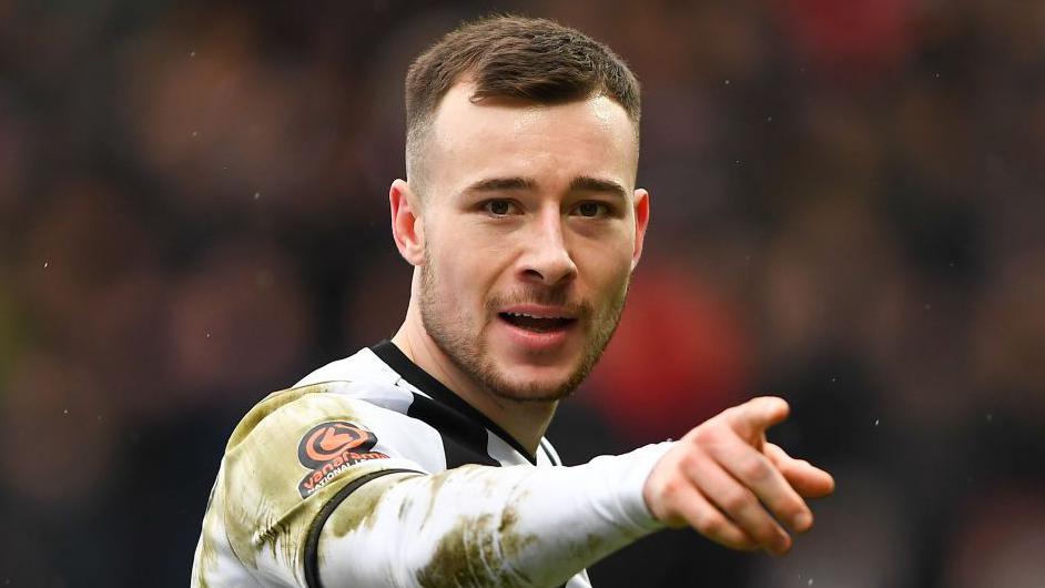 Callum Roberts pointing at the camera. He is wearing a Notts County shirt.