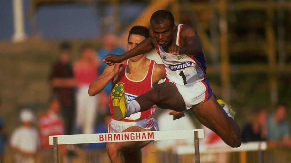 KRISS AKABUSI OF GREAT BRITAIN CLEARS A HURDLE IN THE 400 METRES HURDLES AT THE MCVITIES CHALLENGE HELD TODAY AT THE ALEXANDER STADIUM IN BIRMINGHAM, ENGLAND.