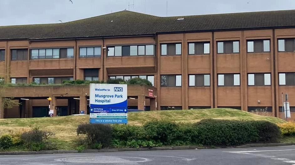 Musgrove Park Hospital in Taunton. It is a red brick building with brown window frames.