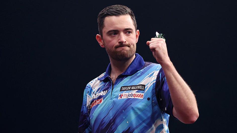 Luke Humphries clenches his fist in celebration