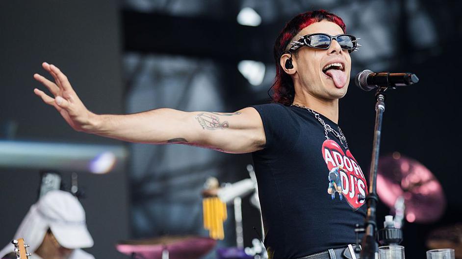 Catriel Guerreiro, of the Argentinian band Ca7riel and Paco Amoroso, sticks his tongue out while performing on stage in Brazil