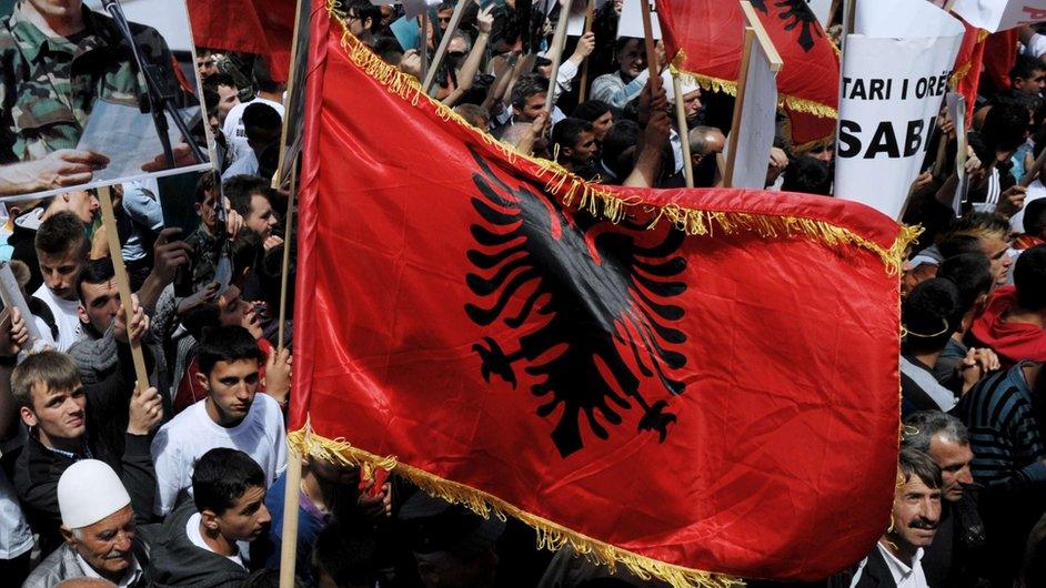 Kosovo Albanians wave Albanian flags and banners as they take part in a protest in Pristina on 27 May 2013