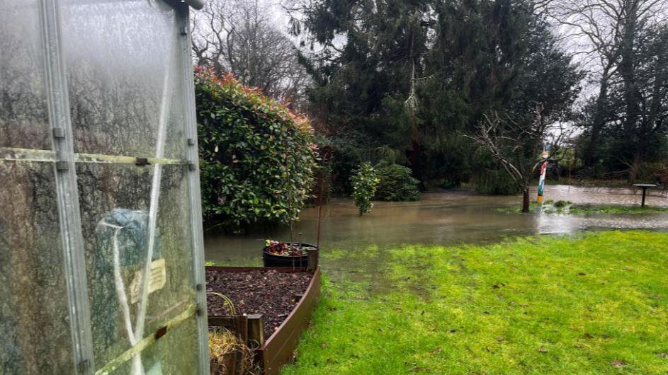 A shot showing a garden in Isfield semi-covered in water