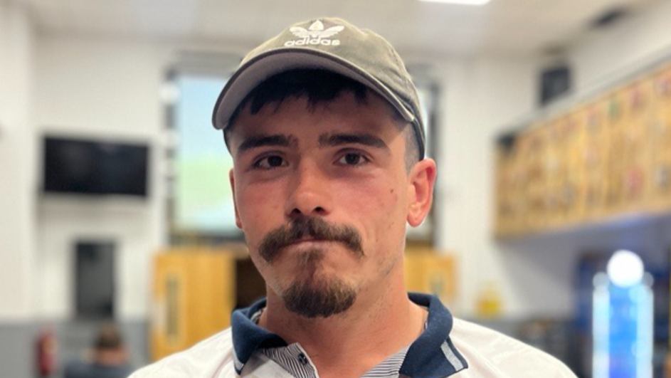 Louie Hurdman, wearing a cap and a blue and white polo shirt