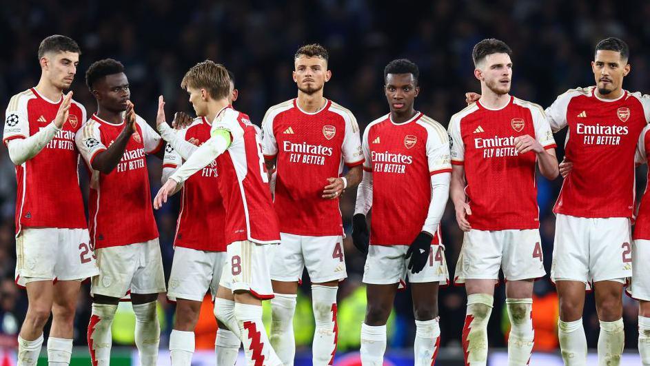 Martin Odegaard is congratulated by his team-mates after scoring the first penalty against Porto in their Champions League round of 16 tie