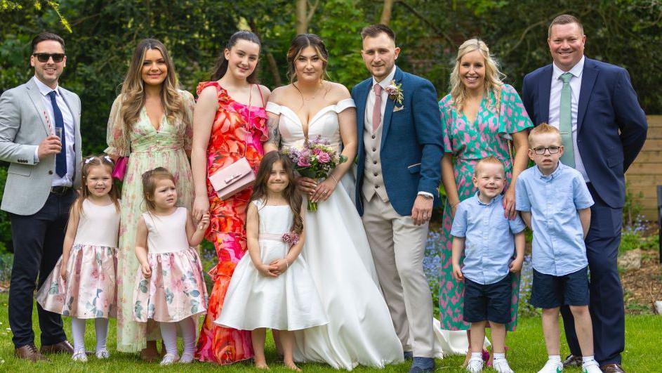 Louise, Danielle and Justine with their partners and children at Danielle's wedding. 