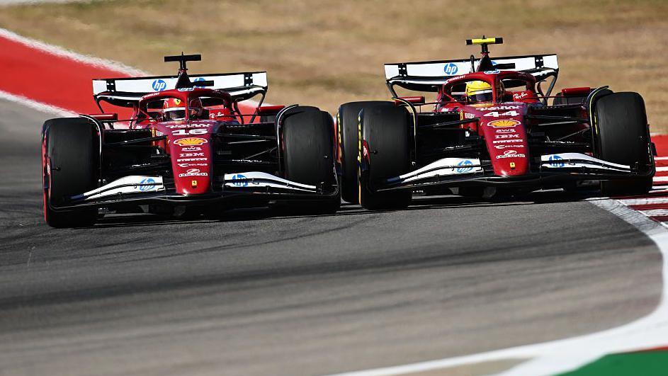 The Ferraris of Charles Leclerc and Lewis Hamilton side by side while battling for third position during the United States Grand Prix