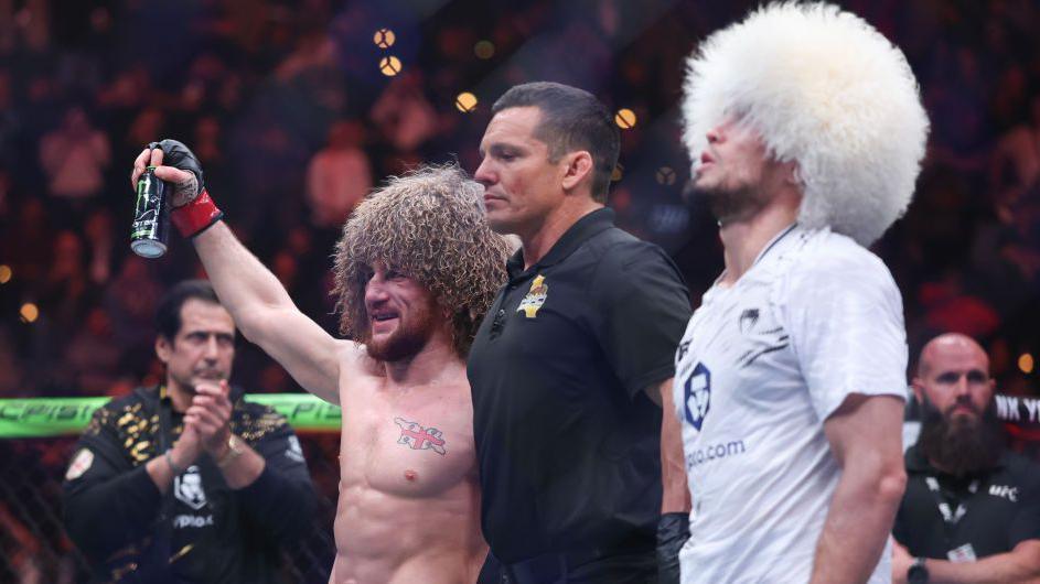 Merab Dvalishvili celebrates as he is confirmed the winner, with Umar Nurmagomedov dejected beside him