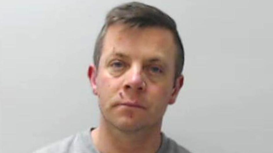 Man - Derek Pearson - looking at camera in police mugshot