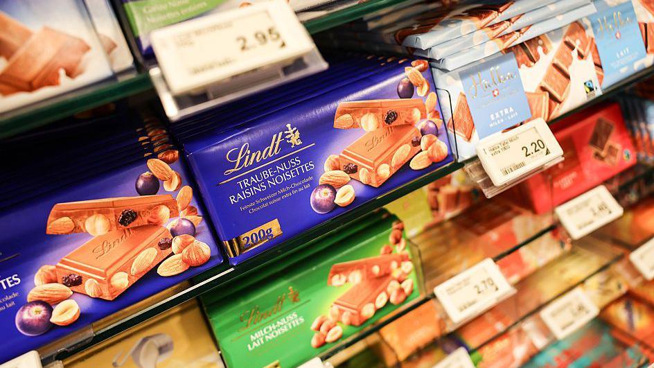 Bars of Swiss chocolate on a shop shelf.