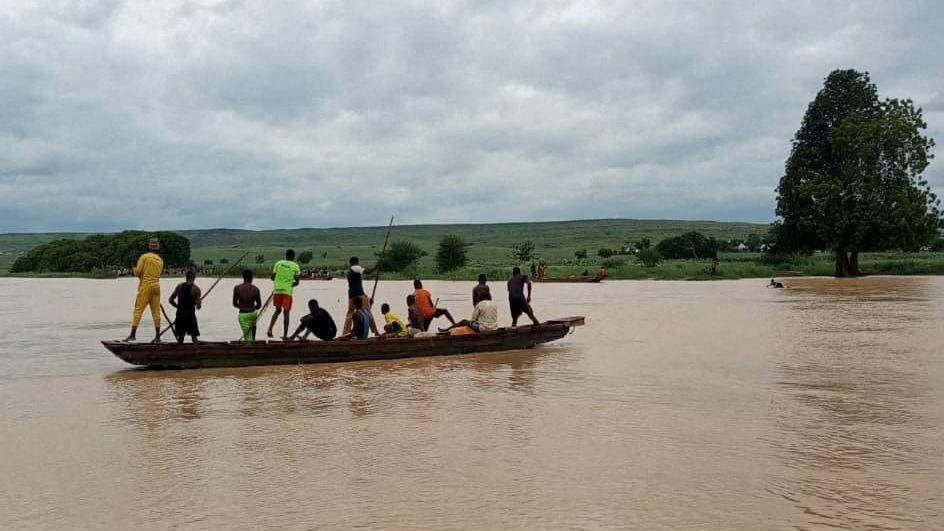 People travel by a boat as search and rescue operations continue following a boat accident, in a place given as Sokoto State, Nigeria, in this handout image released on August 17, 2025.