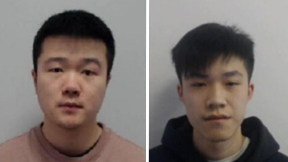 Two men are looking into the camera. One is wearing a dark hoodie and the other is wearing a salmon coloured top. 