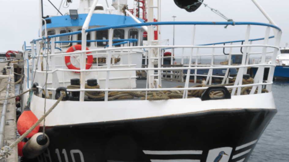 Fishing boat called the Kingfisher tied up in a harbour