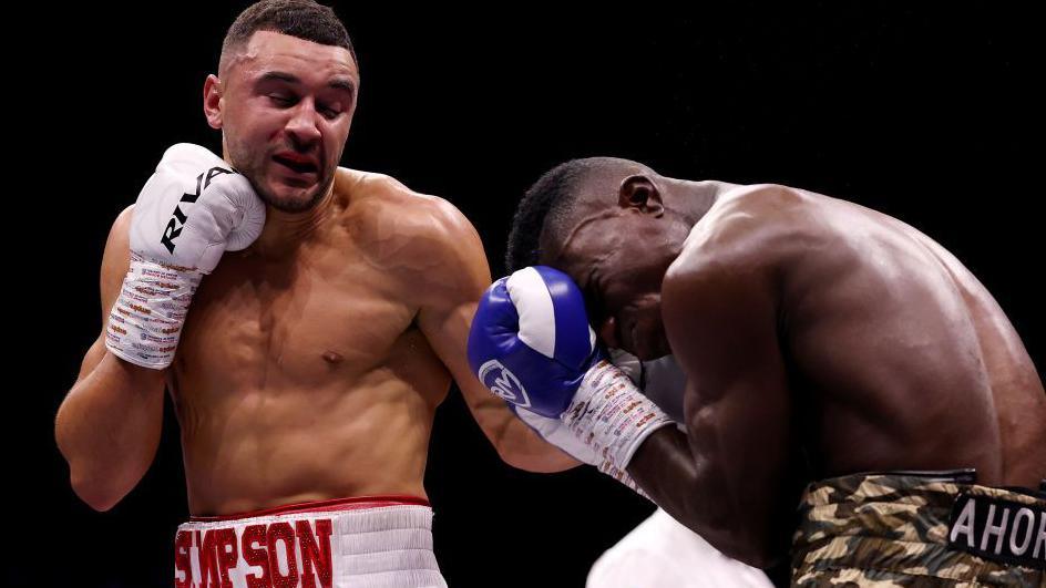 Callum Simpson lands a left hook against Elvis Ahorgah