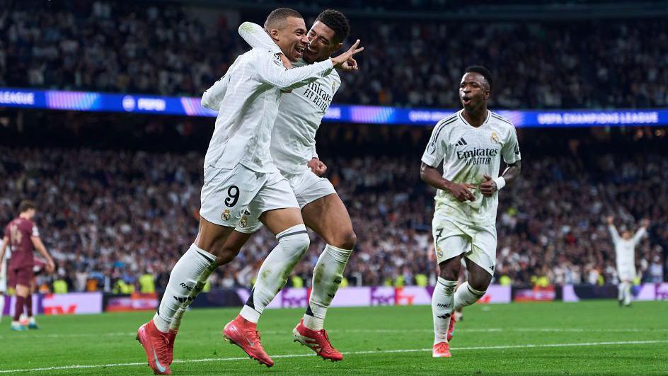 Kylian Mbappe celebrates after scoring his team's third goal with team-mates Jude Bellingham and Vinicius Jr.