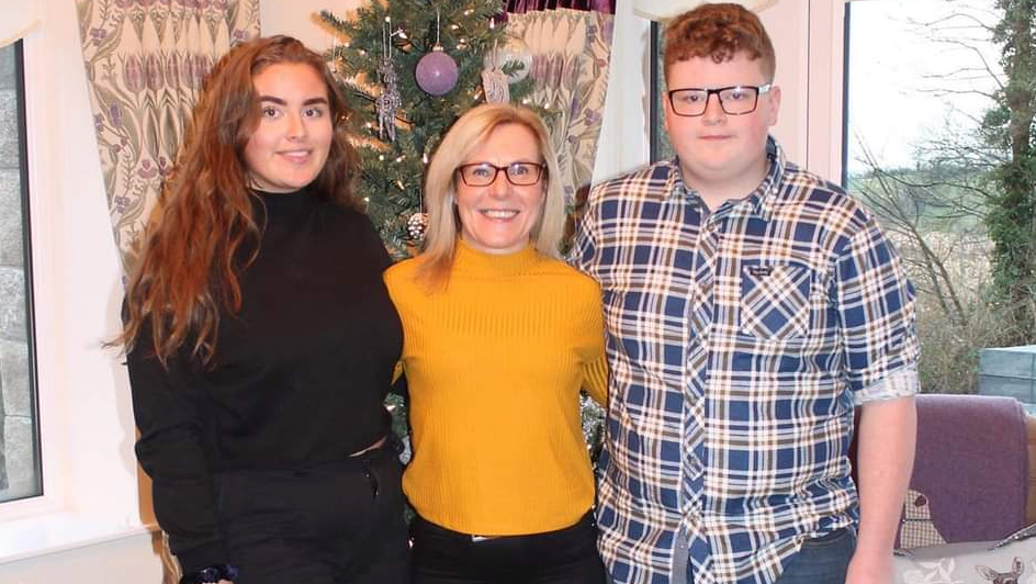 Jeni Larmour standing alongside her mother Sandra and brother Daniel at their home in County Armagh. 