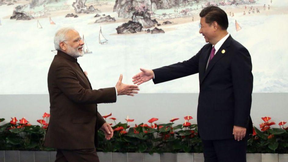 Indian Prime Minister Narendra Modi (L) shakes hands with Chinese President Xi Jinping (R) prior to the dinner on September 4, 2017