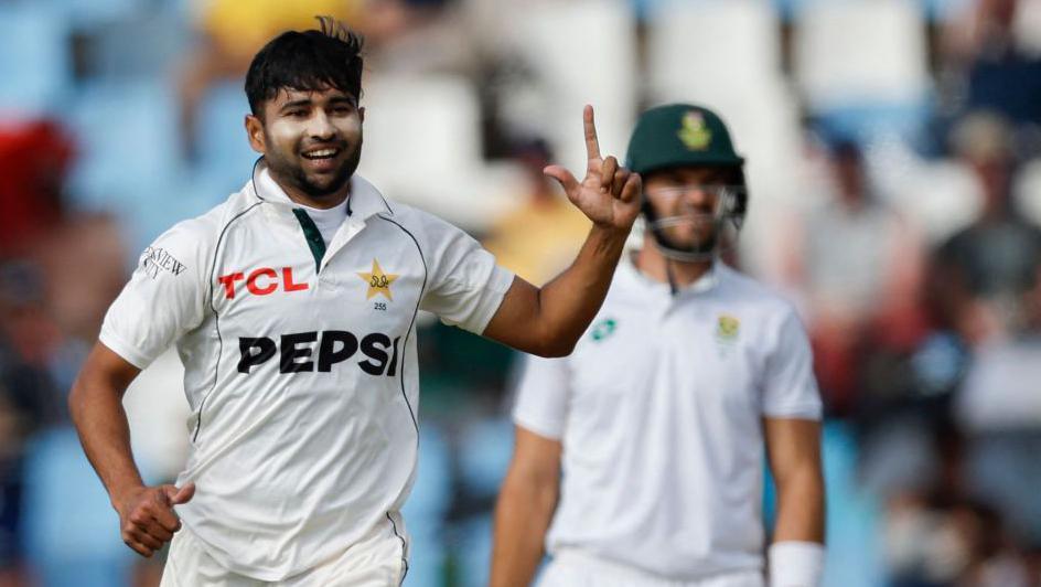 Khurram Shahzad holds his left arm up and points to the sky in celebration at taking a wicket for Pakistan against South Africa