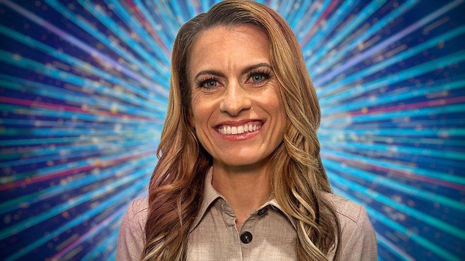 Karen has long honey blonde wavy hair. She is wearing a beige button-up top. She is smiling and standing in front of a blue background with purple, teal and pink stripes which fan out behind her, as well as gold glitter 