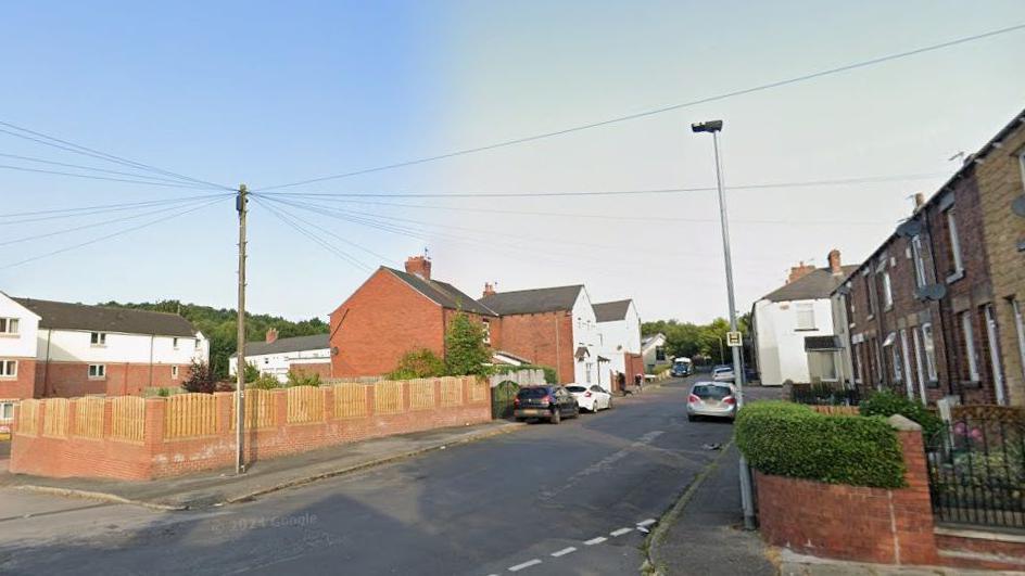 A Google streetview image of a street with some cars lining the side of the roads. This is the scene of the collision.