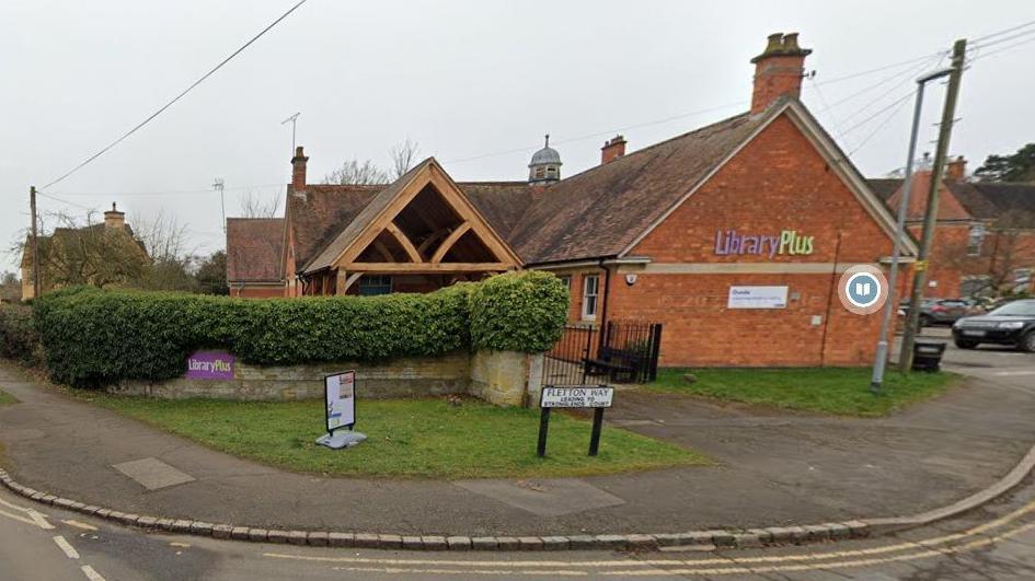 Single-storey brick building with library plus signs