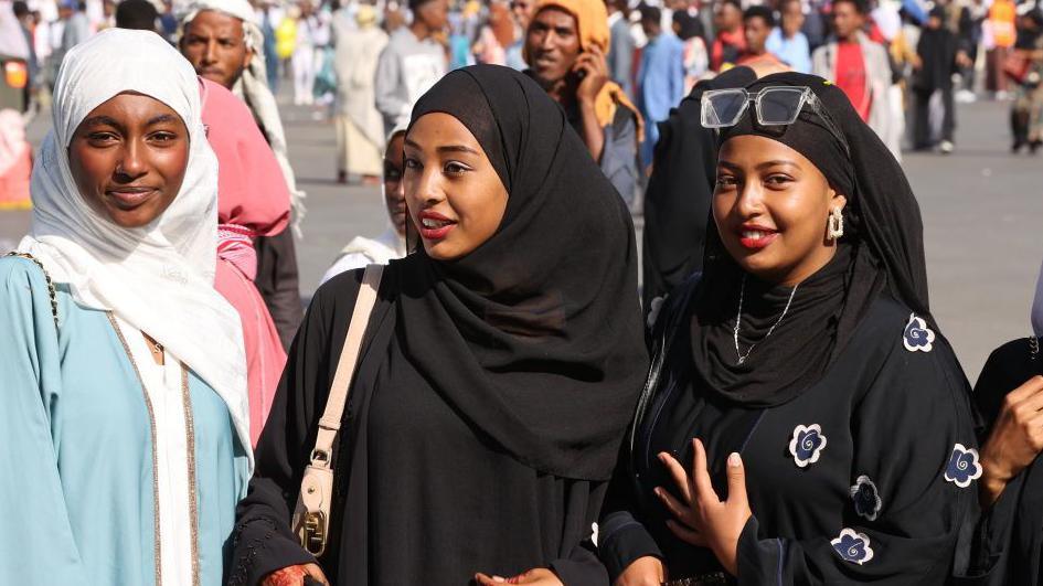 Three girls smiling at the camera