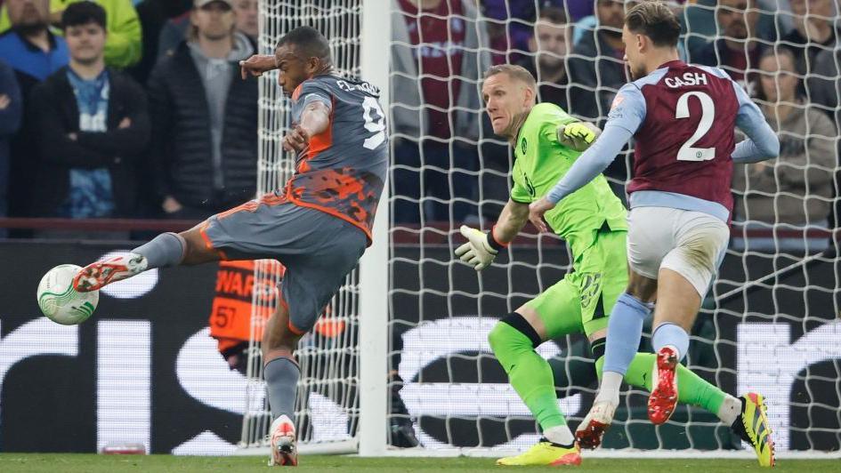 Olympiakos' Ayoub El Kaabi (left) scores against Aston Villa