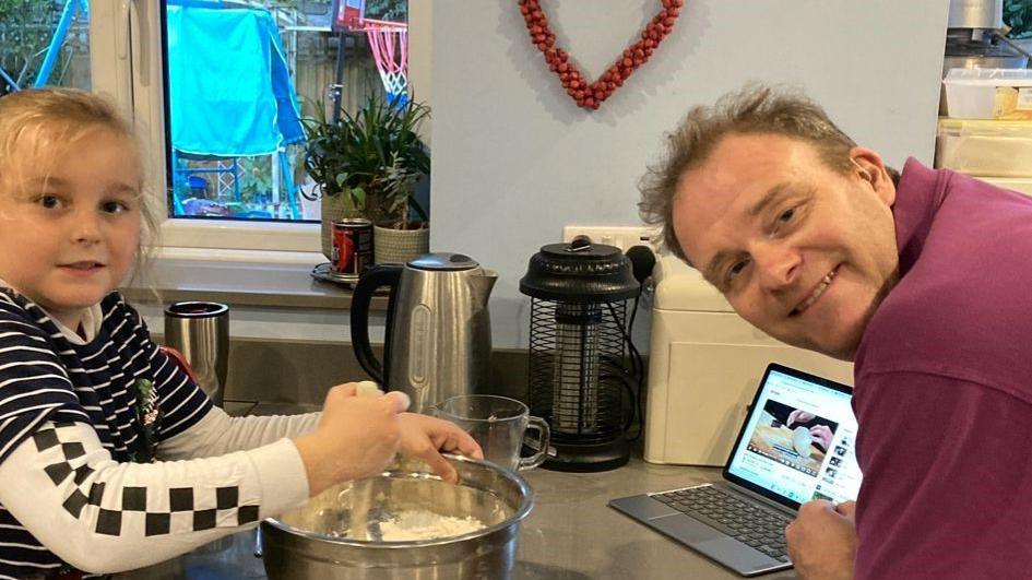 Rossi (left) and his dad Steve (right) baking in the kitchen.