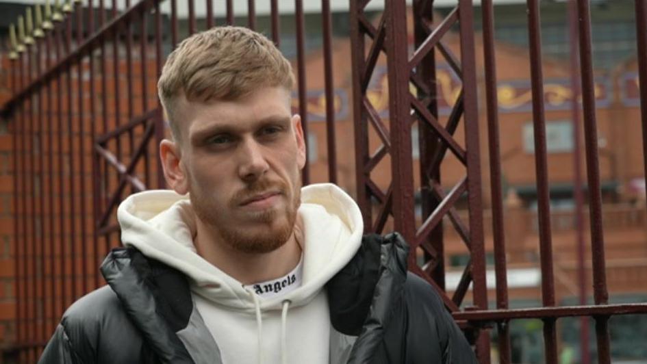 A man standing next to railings