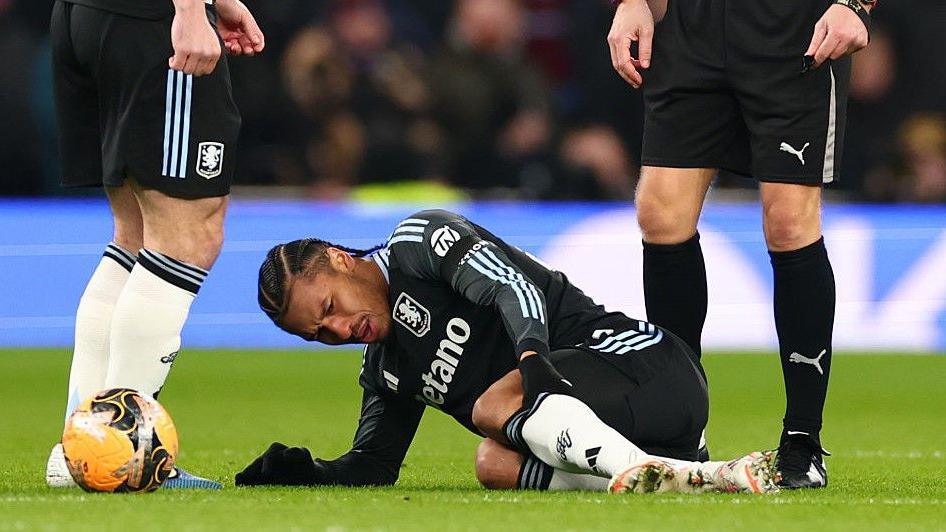 Boubacar Kamara on the ground after suffering a knee injury at Tottenham.