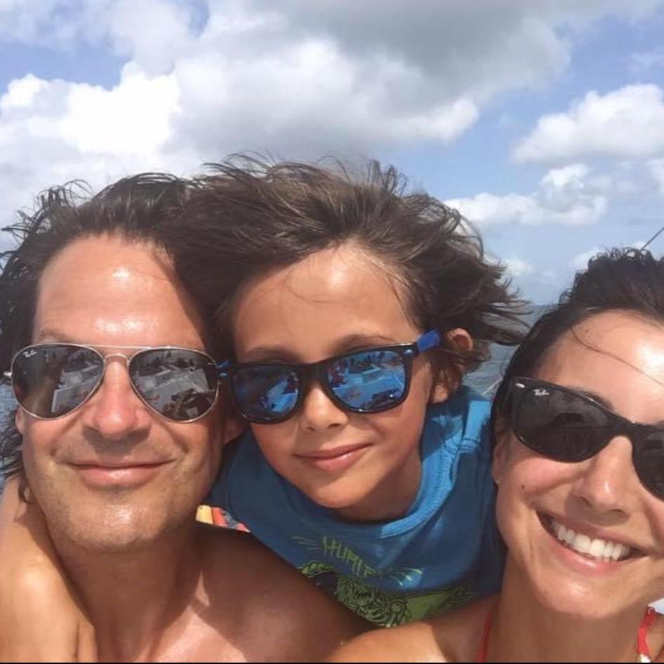 Lucy Owen (right) with her husband Rhodri and their son Gabriel, wearing sunglasses with their arms around each other, smile for a selfie